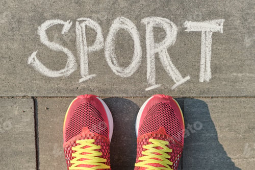 Preview: Word sport written on gray pavement with woman legs in sneakers, view from above