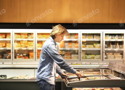 Preview: Man Choosing Frozen Food From A Supermarket Freezer