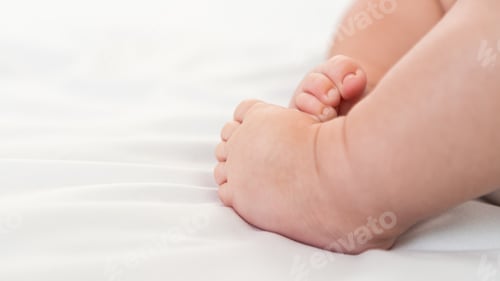Preview: Close up of foots baby in a room with a lot of sunlight. The newborn sleeping