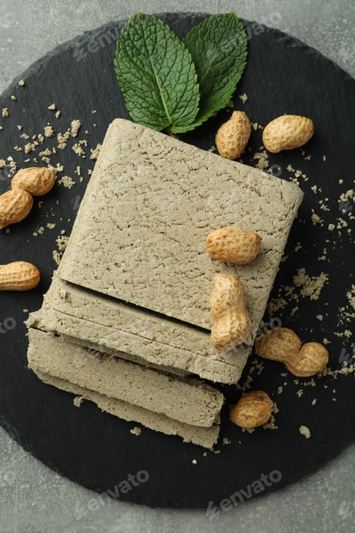 Preview: Concept of tasty food with halva on gray textured background