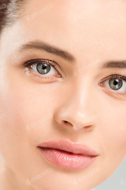 Preview: close up of dreamy woman looking at camera isolated on grey
