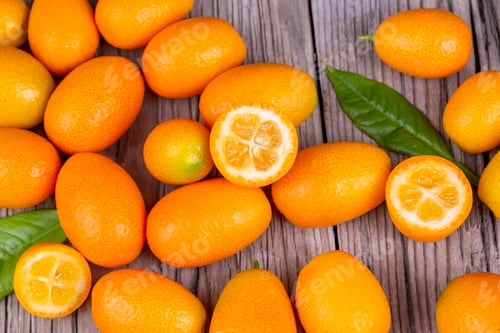 Preview: Top view of bunch of fresh kumquats in the organic food market.