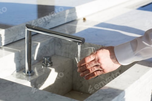 Preview: stylish marble sink with faucet in kitchen-living room. modern urban interior design.