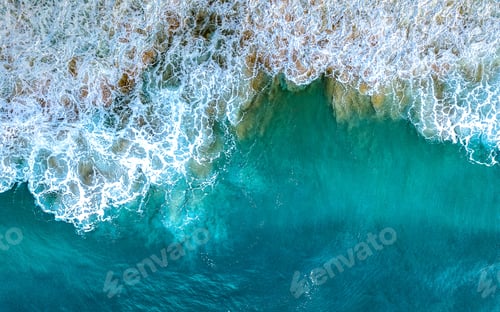 Preview: Arial shot of a breaking wave showing texture and blue hues of the ocean