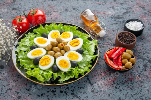 Preview: front view delicious egg salad with tomatoes and olives on light background health tea bread meal