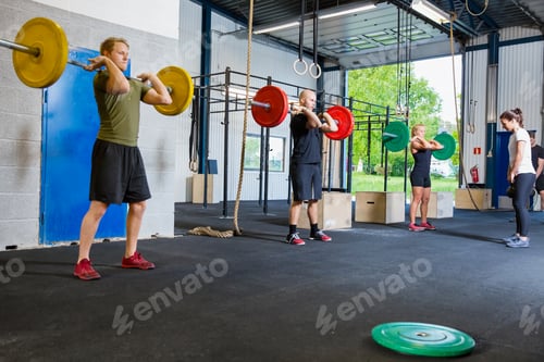 Preview: Team training with weights and kettlebells at fitness gym