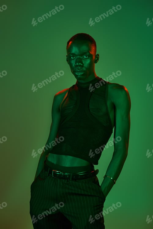 Preview: Young African American man models stylish attire in a creative, well lit space