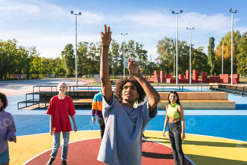 Preview: Multiracial group of young friends bonding outdoors