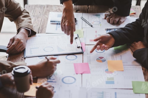 Preview: Financial analysts analyze business financial reports on a digital tablet planning investment projec