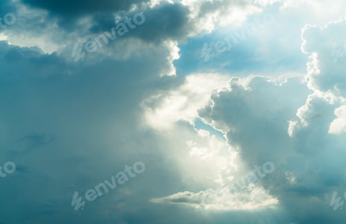 Preview: God light. White and blue cloudy sky with sun beam. Sun rays through white clouds. God light