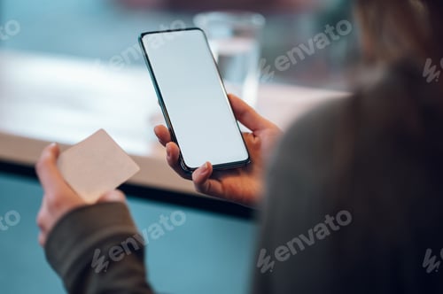 Preview: Close up of a woman hands using smartphone and a credit card