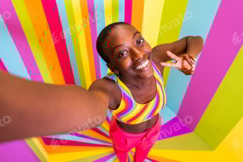 Preview: Beautiful young woman dancing and having fun inside a rainbow box room