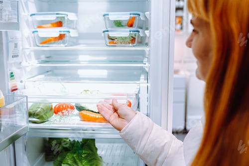 Preview: red-haired woman in store household appliances and kitchen utensils