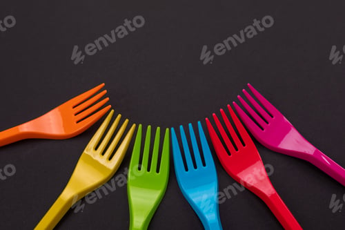 Preview: Many color plastic forks on a bright background