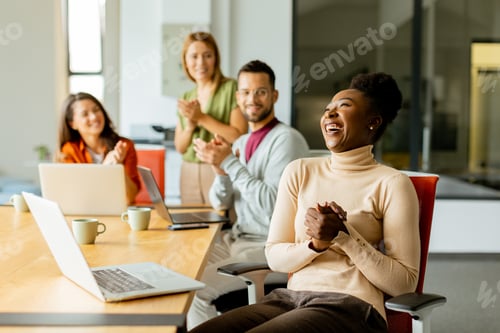 Preview: Cute Africam American woman with her young multiethnic startup team working in the modern office
