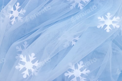 Preview: Creative background of blue tulle and white paper snowflakes.Christmas, New Year, winter concept