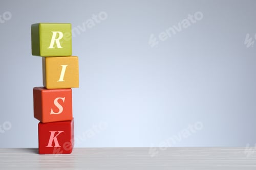 Preview: Risk word make of wooden cubes on table against grey background