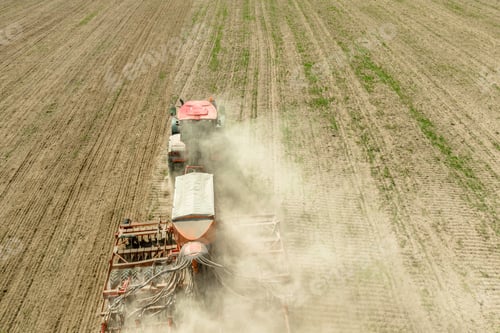 Preview: Aerial View. Tractor With Seed Drill Machine Sowing The Seeds For Crops In Spring Season. Beginning