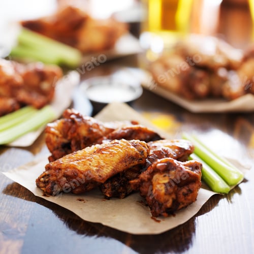 Preview: buffalo barbecue chicken wings on wax paper on wooden table