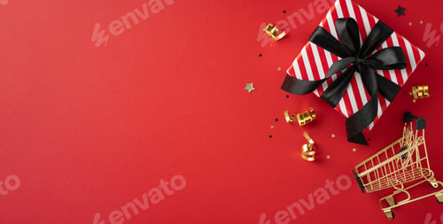 Preview: A striped gift box with a black ribbon and a miniature shopping cart on a red background