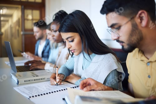 Preview: University, education and students studying for exam, test or assignment in the library on campus.
