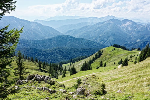 Preview: Breathtaking view of lush green hills and distant mountains.