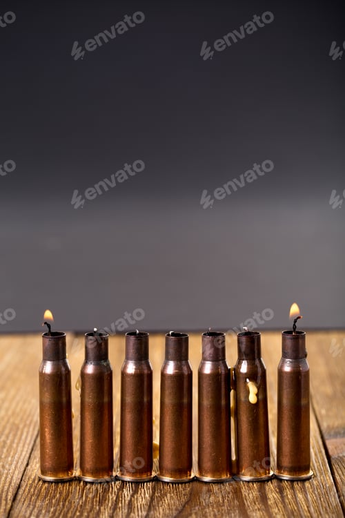 Preview: Burning candles and empty rifle cartridges.