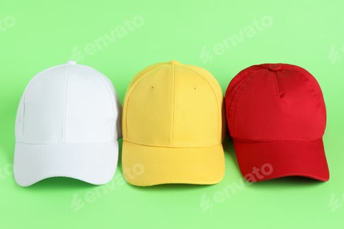 Preview: Colorful baseball hats on light green background