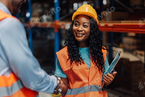 Preview: Female warehouse worker shaking hands with manager