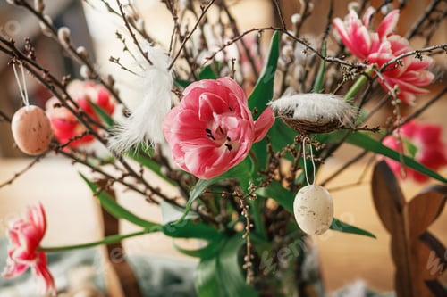 Preview: Stylish tulips bouquet with willow branches, easter eggs and feathers decor on wooden table close up