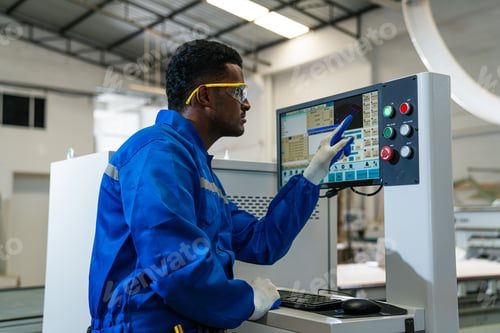 Preview: Modern industrial machine operator working in industrial factory.