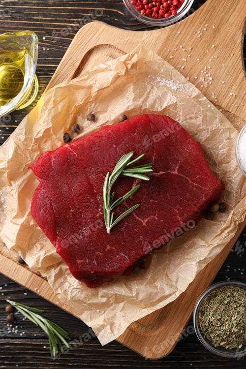 Preview: Concept of tasty food with raw beef steak on wooden background