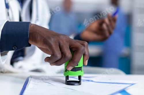 Preview: Close up of general practitioner hand writing prescription painkillers in personal healthcare