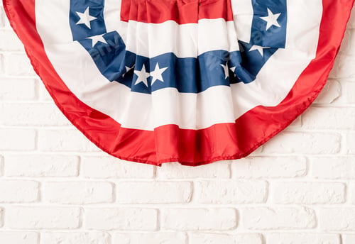 Preview: USA national flag on white brick wall background with copy space