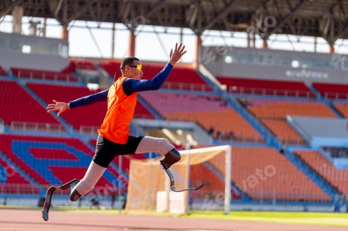 Preview: Asian para-athletes with prosthetic blades sprint on a running track at stadium.