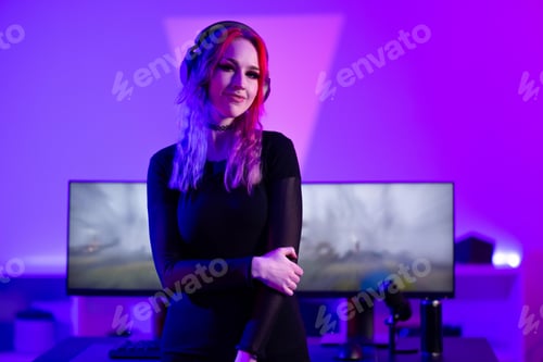Preview: Female gamer streaming in a vibrant gaming studio with glowing purple lights