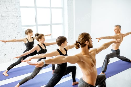 Preview: Group of people practising yoga indoors