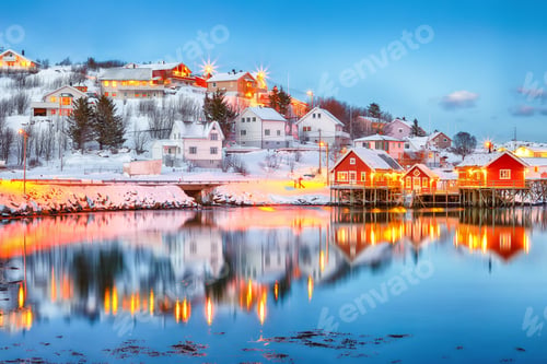 Preview: Dramatic evening cityscape of Reine town. Red rorbuers on the shore of Reinefjorden