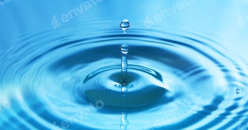 Preview: Water drop falling into water making a perfect concentric circles. Abstract blue background