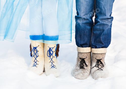 Preview: legs embracing couples standing on the snow snowy winter
