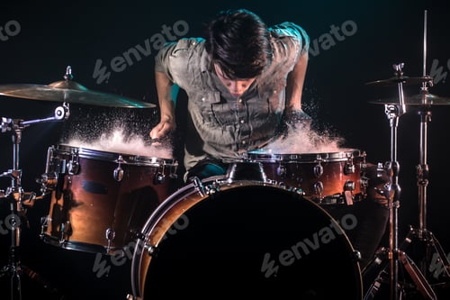 Preview: musician playing drums with splashes, black background with beautiful soft light