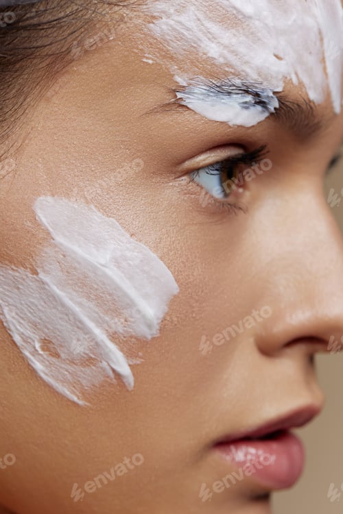 Preview: young woman skin care by using white mask on the face Youth and Skin Care Concept