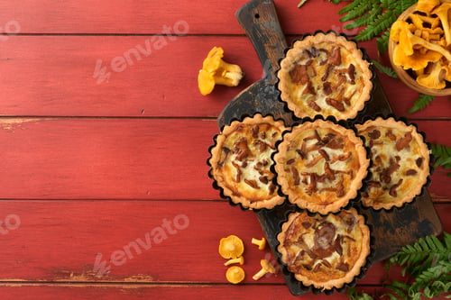 Preview: Savory hands pie with chanterelle mushrooms, cream and cheese on cutting board on rustic old red woo