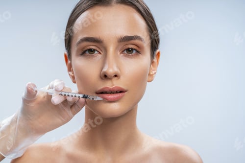 Preview: Beautiful brunette female person staring at camera