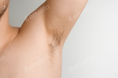 Preview: Close up mans armpit with long hair on white background