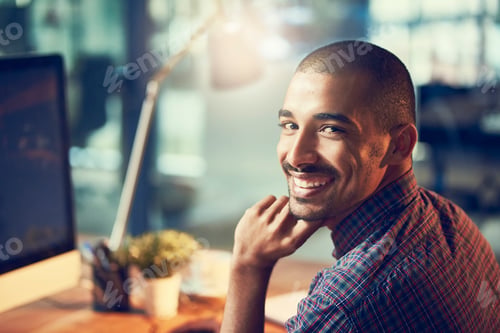 Preview: Hard work yields the best results. Portrait of a young designer working late in an office.