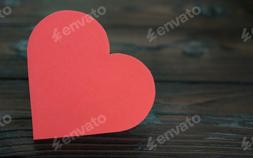 Preview: Cropped shot of Red paper heart on fire wood background for valentine.