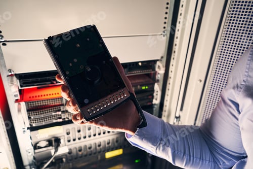Preview: Data center IT technician holding new HDD
