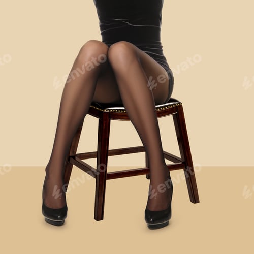 Preview: Slim female long legs in black pantyhose and short dress sitting