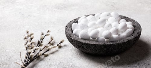 Preview: Easter holiday concept.White small eggs in a plate